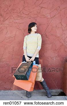 Picture - woman holding 
shopping bags. 
fotosearch - search 
stock photos, 
pictures, images, 
and photo clipart