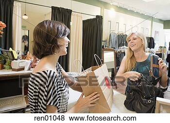 Stock Photo - woman making purchase 
at boutique. fotosearch 
- search stock 
photos, pictures, 
images, and photo 
clipart