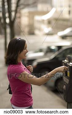 Stock Photo - woman paying parking 
meter. fotosearch 
- search stock 
photos, pictures, 
images, and photo 
clipart