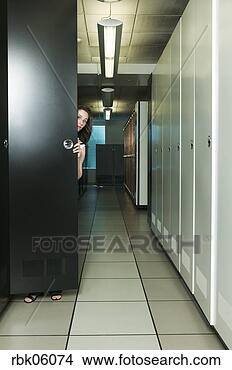 Stock Photo - woman peeking 
out from closet 
door. fotosearch 
- search stock 
photos, pictures, 
images, and photo 
clipart