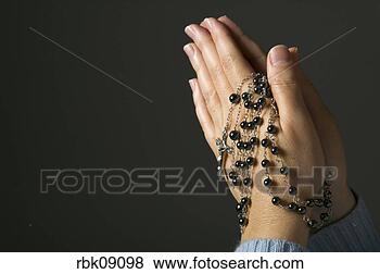 Stock Photo - woman praying 
with rosary beads. 
fotosearch - search 
stock photos, 
pictures, images, 
and photo clipart