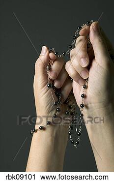 Stock Photography - woman praying 
with rosary beads. 
fotosearch - search 
stock photos, 
pictures, images, 
and photo clipart