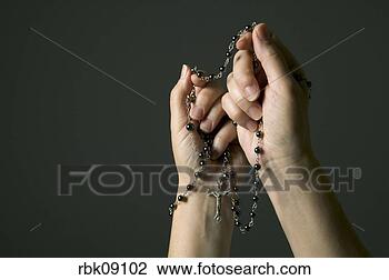 Stock Photo - woman praying 
with rosary beads. 
fotosearch - search 
stock photos, 
pictures, images, 
and photo clipart