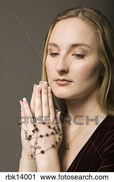 Stock Photography - woman praying 
with rosary beads. 
fotosearch - search 
stock photos, 
pictures, images, 
and photo clipart