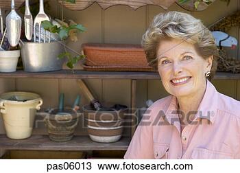 Stock Photo - woman smiling 
with gardening 
tools. fotosearch 
- search stock 
photos, pictures, 
images, and photo 
clipart