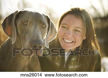 Stock Photo - woman smiling 
with her dog. 
fotosearch - search 
stock photos, 
pictures, images, 
and photo clipart