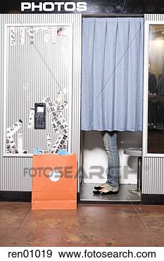 Stock Photograph - woman standing 
in photo booth. 
fotosearch - search 
stock photos, 
pictures, images, 
and photo clipart