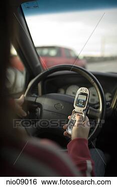 Stock Photo - woman using her 
cell phone while 
driving. fotosearch 
- search stock 
photos, pictures, 
images, and photo 
clipart