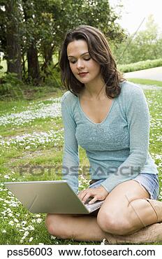 Stock Photo - woman using laptop 
outdoors. fotosearch 
- search stock 
photos, pictures, 
images, and photo 
clipart