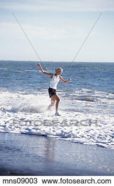 Stock Photo - woman wading in 
ocean. fotosearch 
- search stock 
photos, pictures, 
images, and photo 
clipart