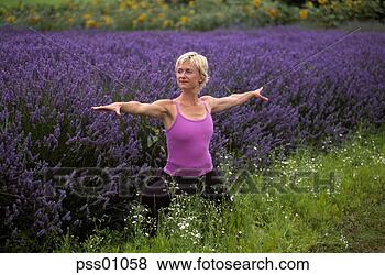 Stock Photo - woman in yoga 
pose near lavender 
field. fotosearch 
- search stock 
photos, pictures, 
images, and photo 
clipart