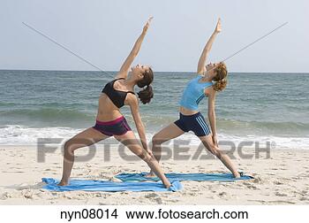 Stock Photo - women practicing 
yoga on beach. 
fotosearch - search 
stock photos, 
pictures, images, 
and photo clipart