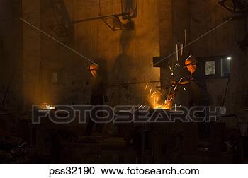 Stock Photography - workers in foundry 
next to casts. 
fotosearch - search 
stock photos, 
pictures, images, 
and photo clipart