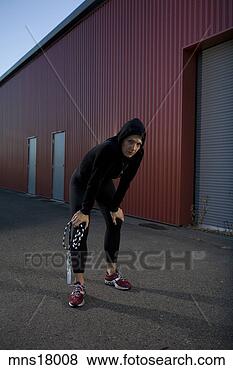 Stock Photo - young adult woman 
resting near warehouse. 
fotosearch - search 
stock photos, 
pictures, images, 
and photo clipart