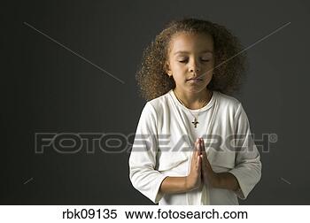 Stock Image - young african 
girl praying. 
fotosearch - search 
stock photos, 
pictures, images, 
and photo clipart