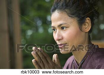 Stock Photo - young asian woman 
praying. fotosearch 
- search stock 
photos, pictures, 
images, and photo 
clipart