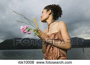 Stock Photo - young asian woman 
praying and holding 
flowers. fotosearch 
- search stock 
photos, pictures, 
images, and photo 
clipart