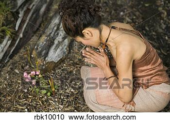 Stock Photography - young asian woman 
kneeling and praying. 
fotosearch - search 
stock photos, 
pictures, images, 
and photo clipart