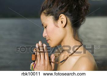 Stock Photography - young asian woman 
praying with prayer 
beads. fotosearch 
- search stock 
photos, pictures, 
images, and photo 
clipart