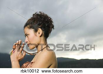 Stock Photo - young asian woman 
praying with prayer 
beads. fotosearch 
- search stock 
photos, pictures, 
images, and photo 
clipart