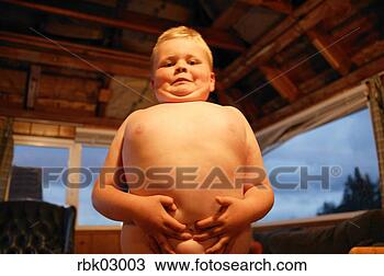 Stock Photo - young boy displaying 
bellybutton. fotosearch 
- search stock 
photos, pictures, 
images, and photo 
clipart