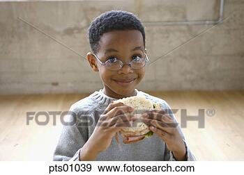 Stock Photograph - young boy wearing 
glasses eating 
sandwich. fotosearch 
- search stock 
photos, pictures, 
images, and photo 
clipart