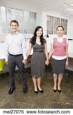 Stock Image - young businesspeople 
holding hands. 
fotosearch - search 
stock photos, 
pictures, images, 
and photo clipart