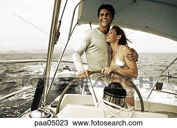 Stock Photo - young couple steering 
boat together. 
fotosearch - search 
stock photos, 
pictures, images, 
and photo clipart