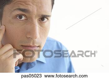 Stock Photo - young hispanic 
man with raised 
eyebrow. fotosearch 
- search stock 
photos, pictures, 
images, and photo 
clipart