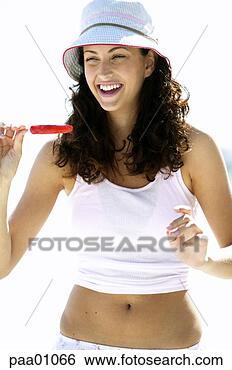 Stock Photo - young hispanic 
woman eating a 
popsicle. fotosearch 
- search stock 
photos, pictures, 
images, and photo 
clipart