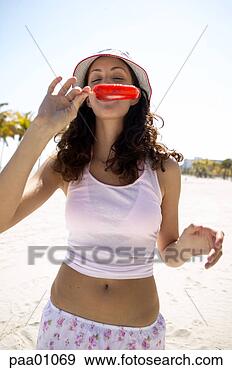 Stock Photograph - young hispanic 
woman eating a 
popsicle. fotosearch 
- search stock 
photos, pictures, 
images, and photo 
clipart