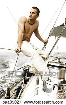 Picture - young man holding 
railing on sailing 
boat. fotosearch 
- search stock 
photos, pictures, 
images, and photo 
clipart