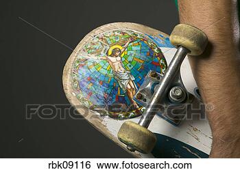 Stock Photo - young man holding 
skateboard with 
religious sticker. 
fotosearch - search 
stock photos, 
pictures, images, 
and photo clipart