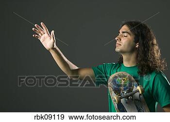 Stock Photograph - young man praying 
and holding skateboard. 
fotosearch - search 
stock photos, 
pictures, images, 
and photo clipart