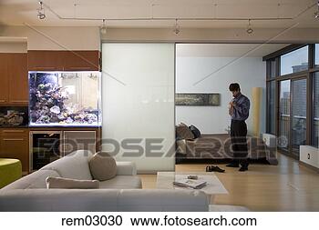 Stock Photography - young man tying 
his tie. fotosearch 
- search stock 
photos, pictures, 
images, and photo 
clipart
