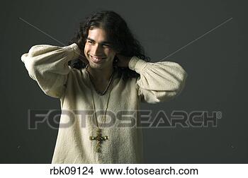 Stock Photo - young man wearing 
cross and smiling. 
fotosearch - search 
stock photos, 
pictures, images, 
and photo clipart