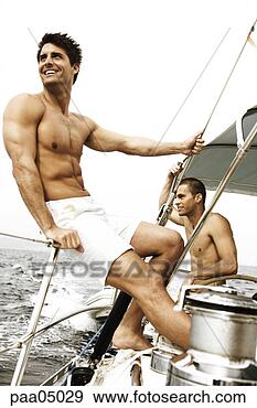 Stock Photograph - young men sailing 
boat together. 
fotosearch - search 
stock photos, 
pictures, images, 
and photo clipart
