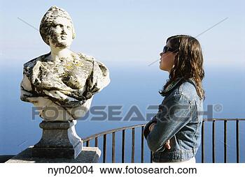 Stock Photo - young woman admiring 
statue. fotosearch 
- search stock 
photos, pictures, 
images, and photo 
clipart