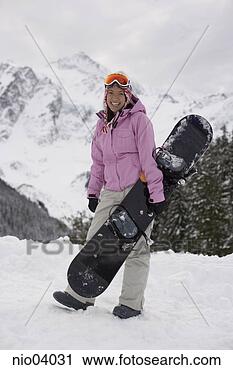 Stock Photography - young woman holding 
snowboard on hilltop. 
fotosearch - search 
stock photos, 
pictures, images, 
and photo clipart
