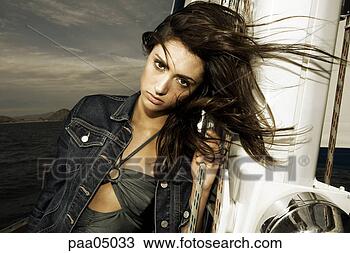 Stock Photo - young woman holding 
rigging on sailing 
boat. fotosearch 
- search stock 
photos, pictures, 
images, and photo 
clipart