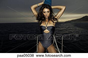 Stock Photo - young woman holding 
mast on sailing 
boat. fotosearch 
- search stock 
photos, pictures, 
images, and photo 
clipart