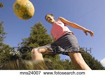 Picture - young woman kicking 
a soccer ball. 
fotosearch - search 
stock photos, 
pictures, images, 
and photo clipart
