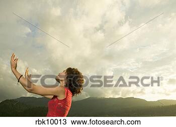 Stock Photo - young woman lifting 
arms to the sky. 
fotosearch - search 
stock photos, 
pictures, images, 
and photo clipart