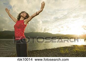 Stock Photo - young woman lifting 
arms to the sky. 
fotosearch - search 
stock photos, 
pictures, images, 
and photo clipart