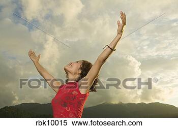 Stock Image - young woman lifting 
arms to the sky. 
fotosearch - search 
stock photos, 
pictures, images, 
and photo clipart