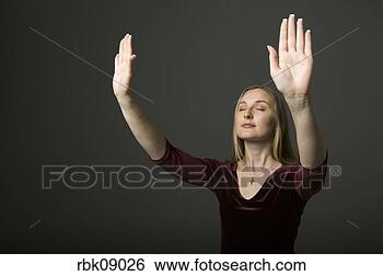 Stock Photo - young woman praying 
with arms lifted. 
fotosearch - search 
stock photos, 
pictures, images, 
and photo clipart