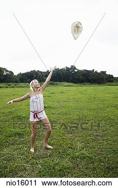 Stock Photography - young woman releasing 
balloon in field. 
fotosearch - search 
stock photos, 
pictures, images, 
and photo clipart