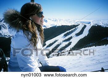 Stock Photo - young woman riding 
ski lift. fotosearch 
- search stock 
photos, pictures, 
images, and photo 
clipart