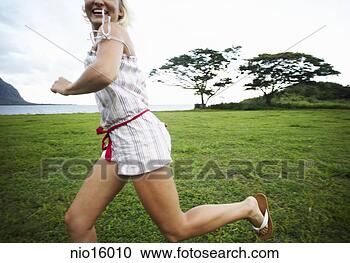 Stock Photography - young woman running 
through field. 
fotosearch - search 
stock photos, 
pictures, images, 
and photo clipart