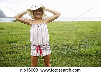 Stock Photograph - young woman wearing 
straw hat. fotosearch 
- search stock 
photos, pictures, 
images, and photo 
clipart